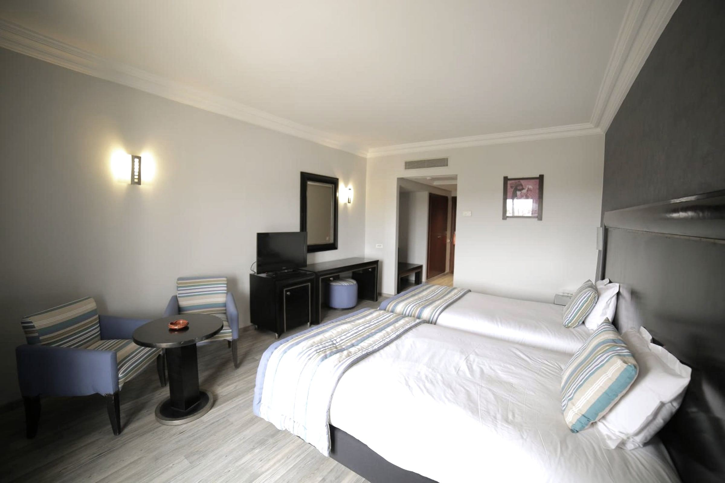 Twin-bedded room, white linen, French window to the balcony