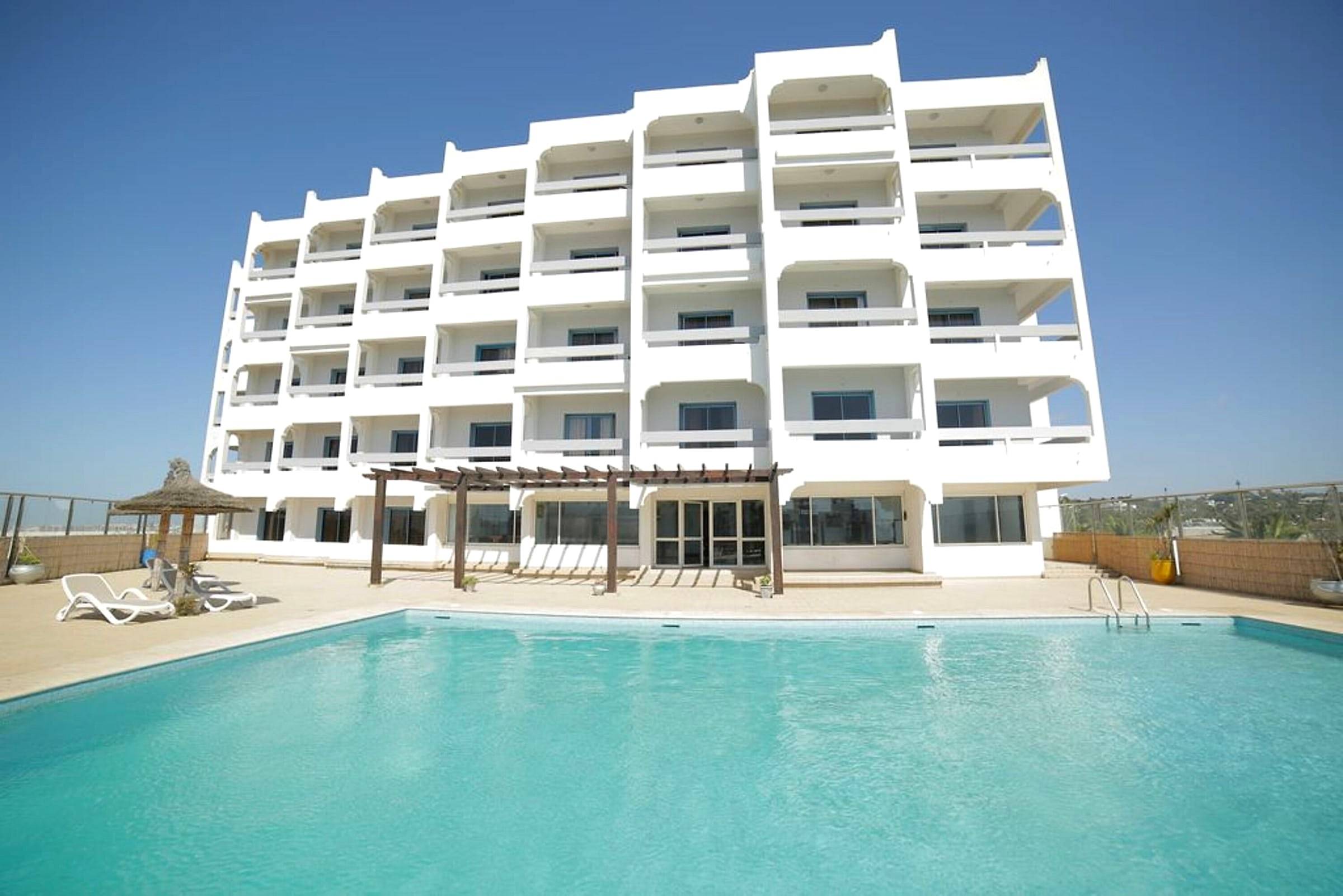 La piscine en terrasse et la façade